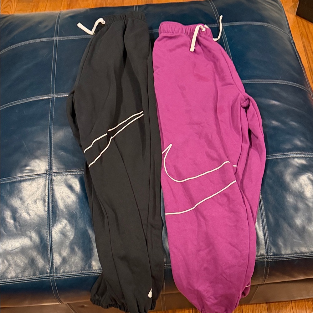 Kids Black and Purple pairs of Nike Sweatpants